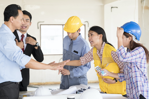 group of people arguing in a construction setting