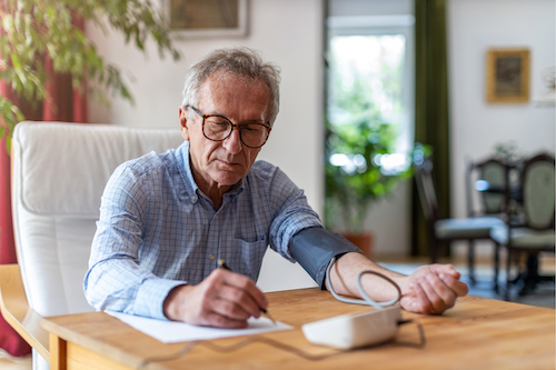 huber thomas marcelle_man taking blood pressure test medical device writing