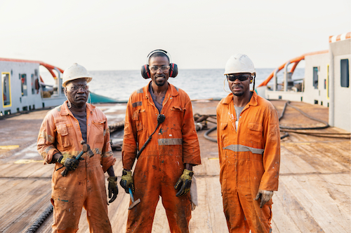 huber-thomas-marcelle_men-standing-on-deepwater-rig-smile